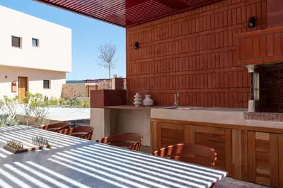 an outdoor kitchen with a table and a sink at Nisi Living Concept in Ialyssos