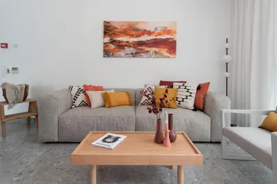 a living room with a couch and a coffee table at Nisi Living Concept in Ialyssos