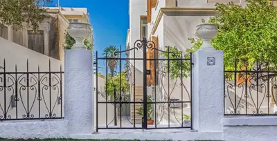 a iron gate with two vases on top of it at Luxury Living Nisos Vs Rhodes town in Rhodes Town