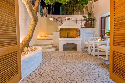 a patio with stairs and a table and a tree at Luxury Living Nisos Vs Rhodes town in Rhodes Town