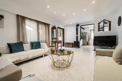a living room with two couches and a tv at Bella Terra Villa Filerimos in Rhodes Town