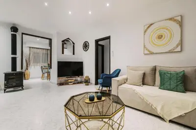 a living room with a couch and a tv at Bella Terra Villa Filerimos in Rhodes Town