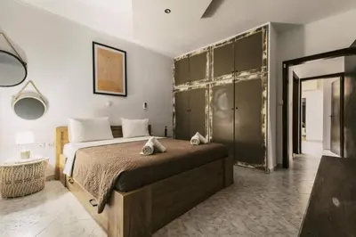 a bedroom with a large bed and a mirror at Bella Terra Villa Filerimos in Rhodes Town
