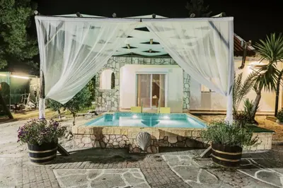 a house with a swimming pool with a curtain over it at Bella Terra Villa Filerimos in Rhodes Town