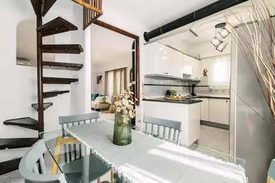 a kitchen and dining room with a table and chairs at Bella Terra Villa Filerimos in Rhodes Town