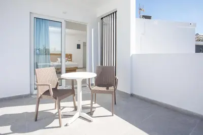 a table and chairs in a room with a dining room at Mando Living -Faliraki in Faliraki