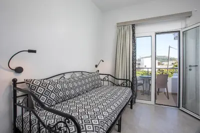 a bedroom with a bed and a balcony at Mando Living -Faliraki in Faliraki