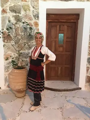 a woman is standing in front of a door at Anastasia's Home in Émbonas