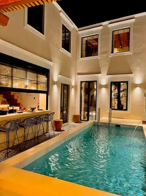 a swimming pool in a house with a bar at Katoikía Pateliá in Koskinou