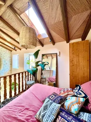a bedroom with a bed with pillows on it at Katoikía Pateliá in Koskinou