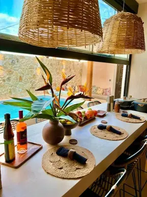 a kitchen counter with three mats and bottles of wine at Katoikía Pateliá in Koskinou