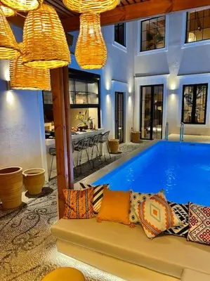 a house with a large swimming pool in the middle at Katoikía Pateliá in Koskinou