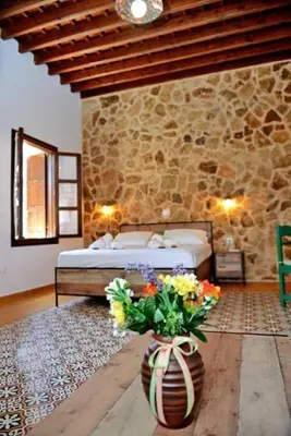 a bedroom with a bed and a vase with flowers in it at Meandros Suite in Old Town in Rhodes Town