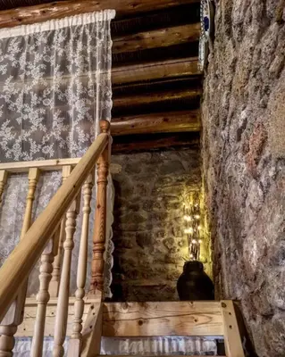 a staircase in a house with a stone wall at M&M STONE-Village House-Family-Vintage in Líndos