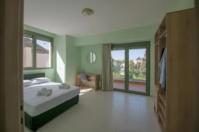 a bedroom with a bed and a large window at Eden Lily- Luxurious Apartment with Sea View in Rhodes Town