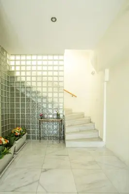 a staircase in a building with white tiles at Eden Lily- Luxurious Apartment with Sea View in Rhodes Town