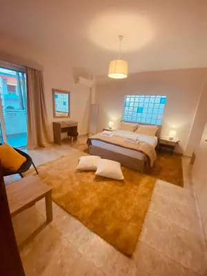 a large bedroom with a bed and a table at Bon Bonheur apartments in Rhodes Town