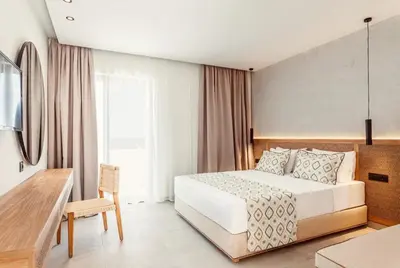 a hotel room with a bed and a desk at Blue Sea Island in Kolimbia