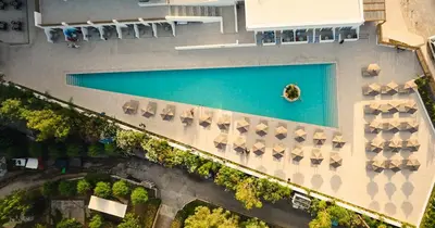 an overhead view of a pool with umbrellas at Blue Sea Island in Kolimbia