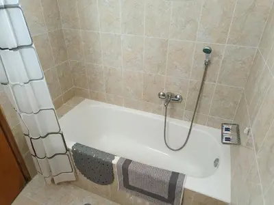 a bath tub in a bathroom with a shower at Chrysa Apartments in Kolimbia