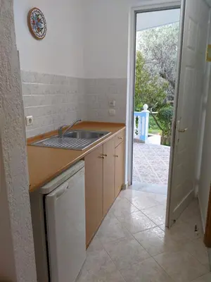 a kitchen with a sink and a counter top at Chrysa Apartments in Kolimbia