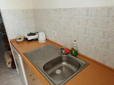 a kitchen counter with a sink in a kitchen at Chrysa Apartments in Kolimbia