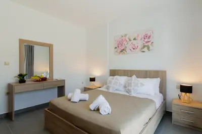 a bedroom with a bed with two towels on it at Aleanna Cozy Luxury Apartments in Rhodes Town