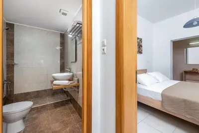 a bathroom with a bed and a toilet and a sink at Aleanna Cozy Luxury Apartments in Rhodes Town