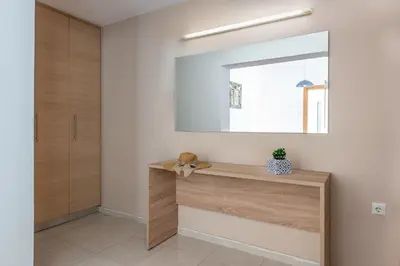 a hallway with a mirror and a wooden table at Aleanna Cozy Luxury Apartments in Rhodes Town