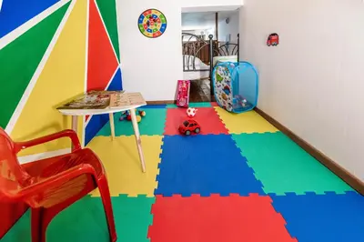 a room with a colorful floor with a table and a chair at Haraki Elegant View in Haraki