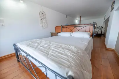 a bedroom with a large bed with white sheets at Haraki Elegant View in Haraki