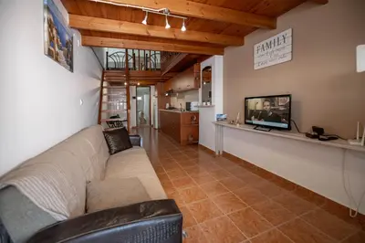 a living room with a couch and a flat screen tv at Haraki Elegant View in Haraki