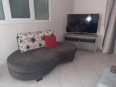 a living room with a couch and a television at Maisonnete Lilian in Rhodes Town