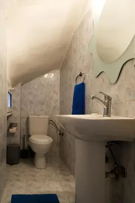a bathroom with a sink and a toilet at Maisonnete Lilian in Rhodes Town
