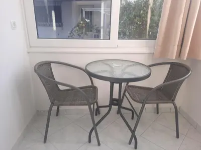 a table and two chairs and a table and two windows at Maisonnete Lilian in Rhodes Town