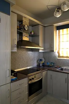 a kitchen with white cabinets and a stove top oven at Maisonnete Lilian in Rhodes Town