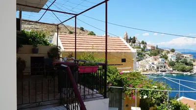 a balcony of a house with a view of the water at Villa Astradeni Symi in Symi