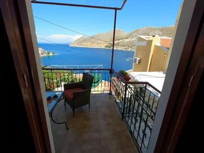 a balcony with a view of the water at Villa Astradeni Symi in Symi