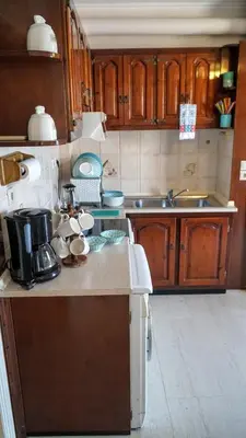 a kitchen with wooden cabinets and a counter top at Villa Astradeni Symi in Symi