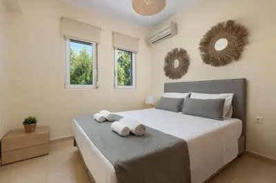 a bedroom with a large bed with towels on it at Villa Olvia in Gennadi