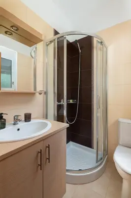 a bathroom with a shower and a sink at Villa Olvia in Gennadi