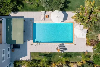 an overhead view of a swimming pool with umbrellas at Villa Olvia in Gennadi