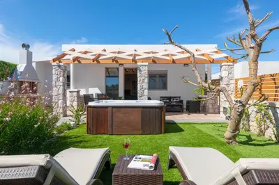 a backyard with a hot tub and a pergola at Casa Bonita Afandou in Rhodes Town