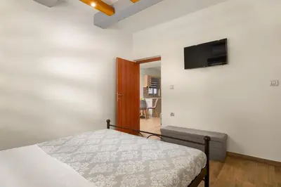 a bedroom with a bed and a flat screen tv at Casa Bonita Afandou in Rhodes Town
