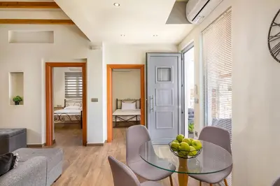 a living room with a glass table and chairs at Casa Bonita Afandou in Rhodes Town