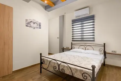 a bedroom with a bed and a window at Casa Bonita Afandou in Rhodes Town