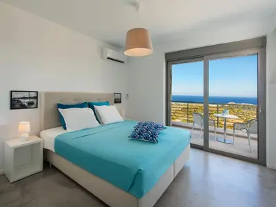 a bedroom with a bed with a view of the ocean at Villa in Rhodes with Infinity Pool in Kalithies
