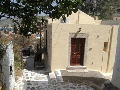 a building with a door on the side of it at GRANDMA'S HOUSE in Symi