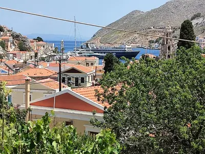 a view of a city with houses and the ocean at GRANDMA'S HOUSE in Symi