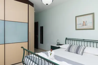 a bedroom with a bed and a sliding glass door at Palamoutaki Villa in Koskinou